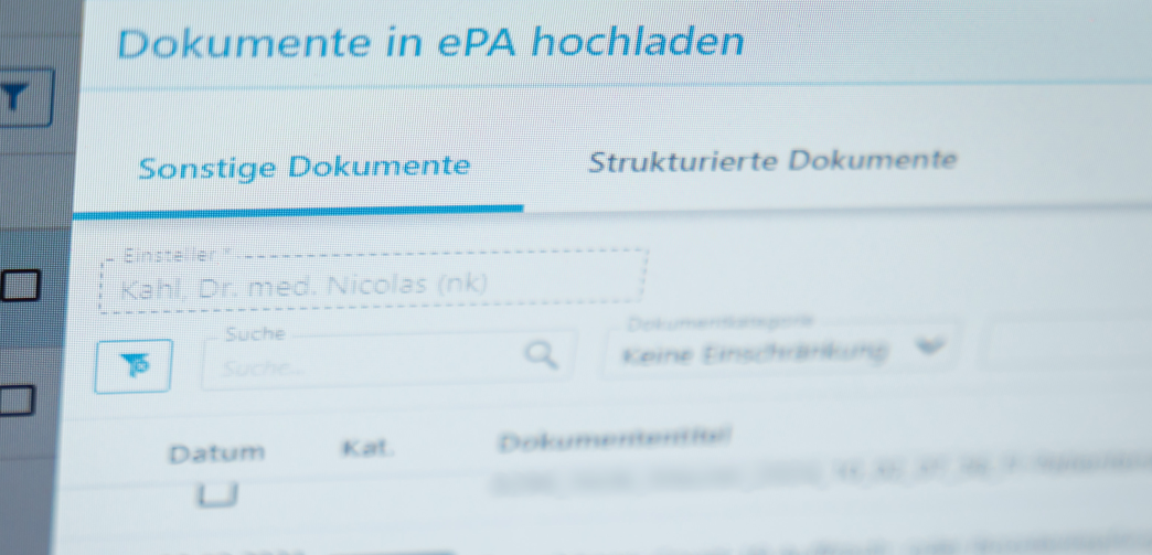 ePA für alle - Elektronische Patientenakte startet bundesweit Ein Hausarzt lädt in seiner Praxis Dokumente in eine elektronische Patientenakte "ePA".