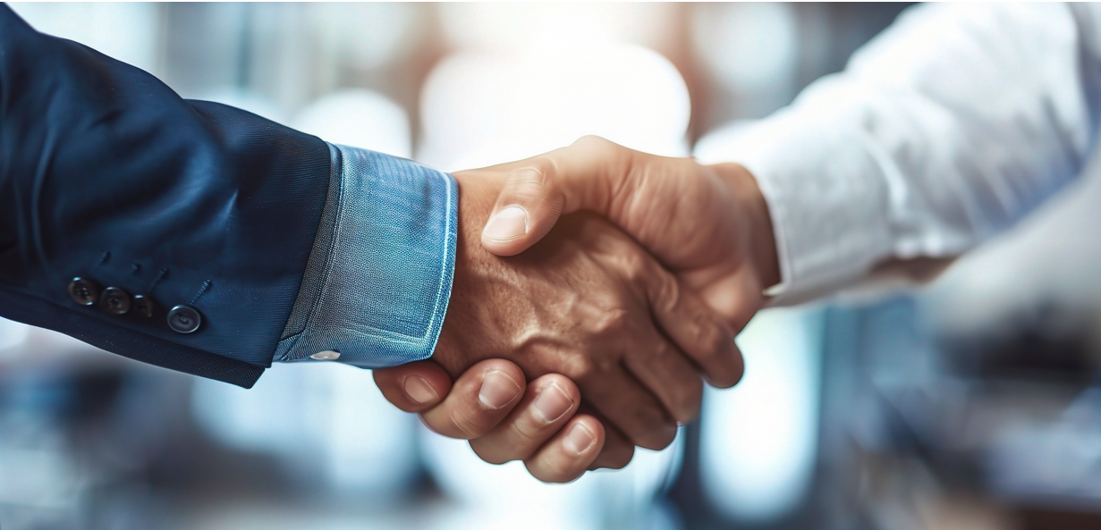 Handschlag zweier Geschäftspartner Handschlag zweier Geschäftspartner