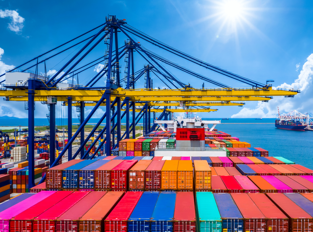 German exports: sentiment improves, upward trend fails to materialize Container ship unloads in deep-sea port - global business logistics, import and export, freight and transportation traffic open overseas with container ship