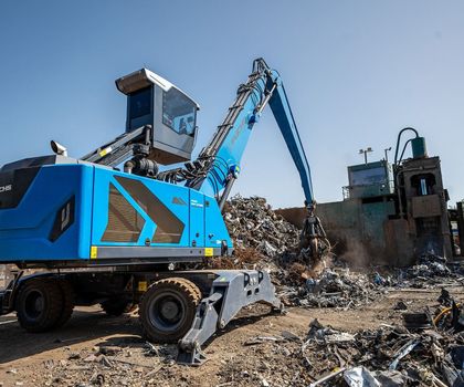 Ein blauer Fuchs Bagger Ein blauer Fuchs Bagger, der mit sienem Schalengreifer Schrott sortiert