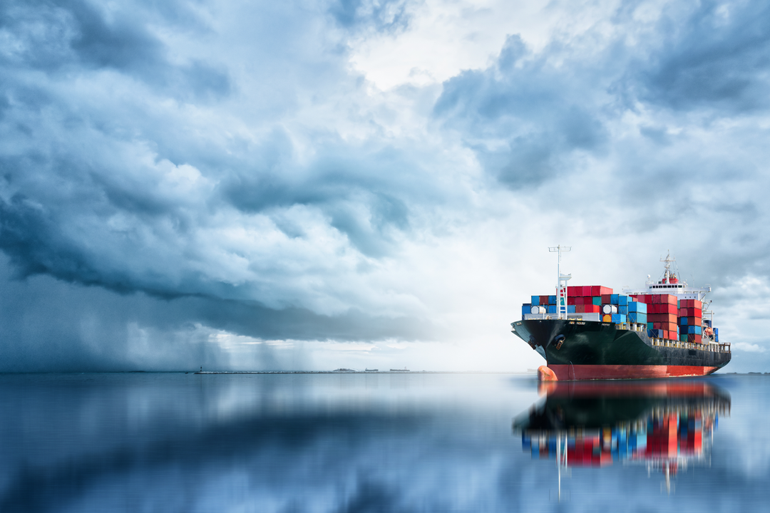 Containerschiff mit dunkel bewölktem Himmel