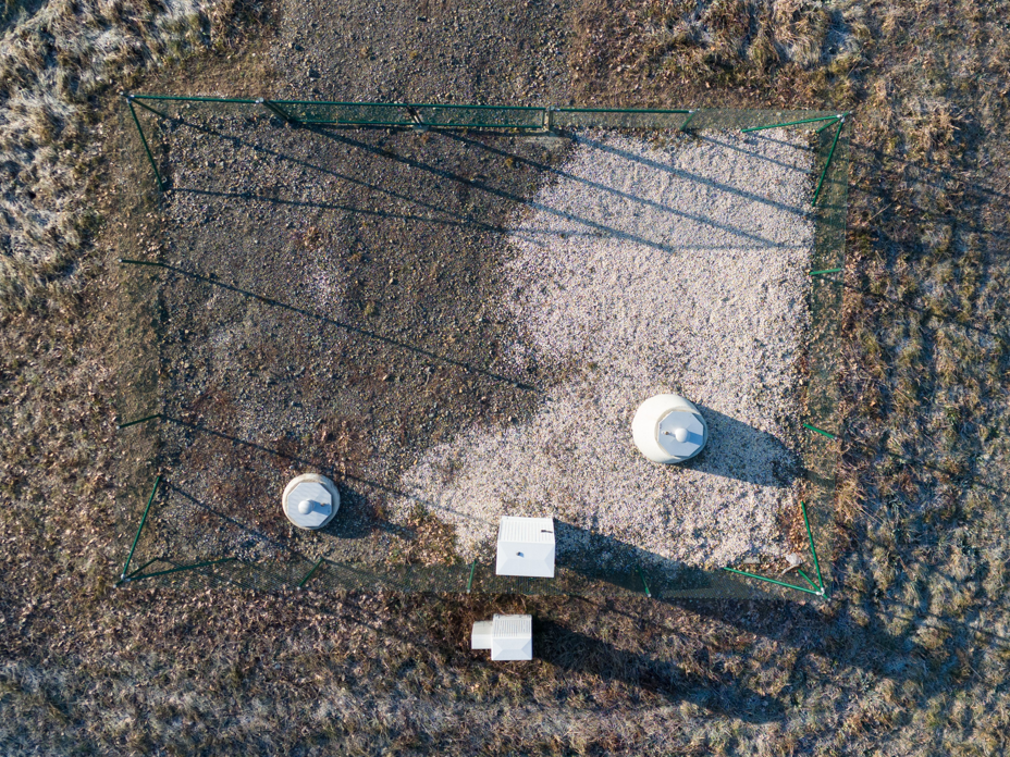 Gravimeter-Messungen in der Lausitz: Standortsuche für unterirdisches Astrophysik-Labor Ein Zaun umgibt eine Messstation des Deutschen Zentrums für Astrophysik (DZA) zur Erforschung und Entwicklung eines Untergrundlabors, des Low Seismic Lab, sowie möglicher Standort für das Einstein Teleskop (Luftaufnahme mit einer Drohne).