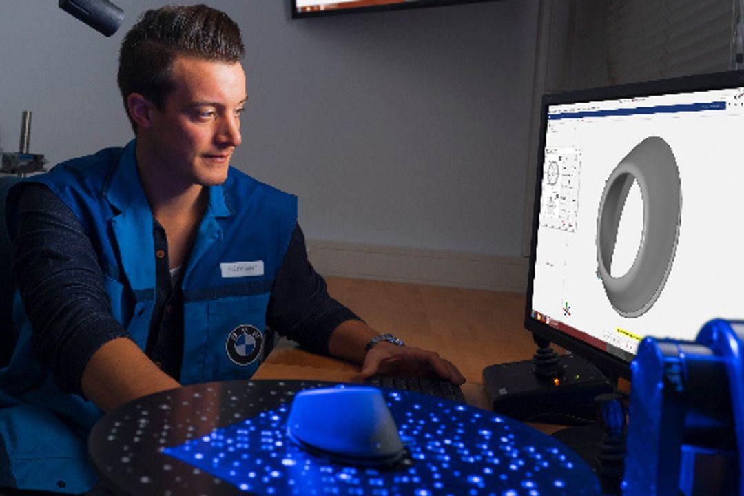 BMW employees analyzing a printed component BMW employees analyzing a printed component