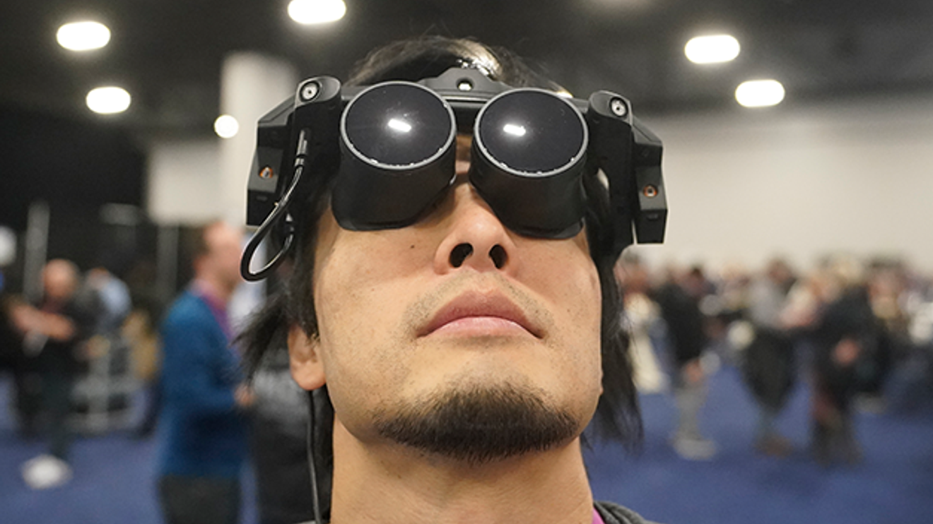 Takuma Iwasa demonstrates the Megane X at the Shiftall stand during the CES technology fair. The Megane X is an ultra-light and ultra-compact VR headset that is compatible with SteamVR. Takuma Iwasa demonstrates the Megane X at the Shiftall stand during the CES technology fair. The Megane X is an ultra-light and ultra-compact VR headset that is compatible with SteamVR.