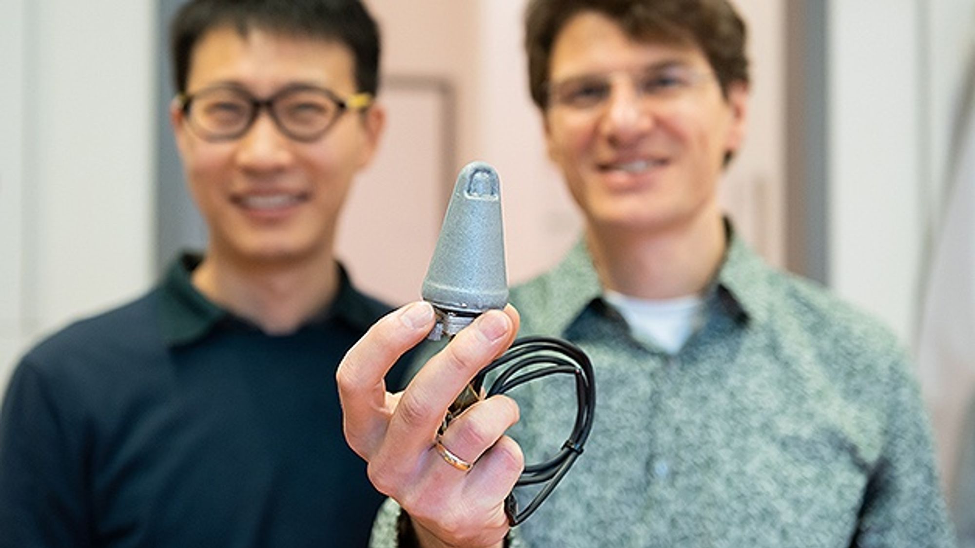 Georg Martius (right), research group leader at the Max Planck Institute, and his doctoral student Huanbo Sun hold a robotic thumb that they developed together at the Institute Georg Martius (right), research group leader at the Max Planck Institute, and his doctoral student Huanbo Sun hold a robotic thumb that they developed together at the Institute