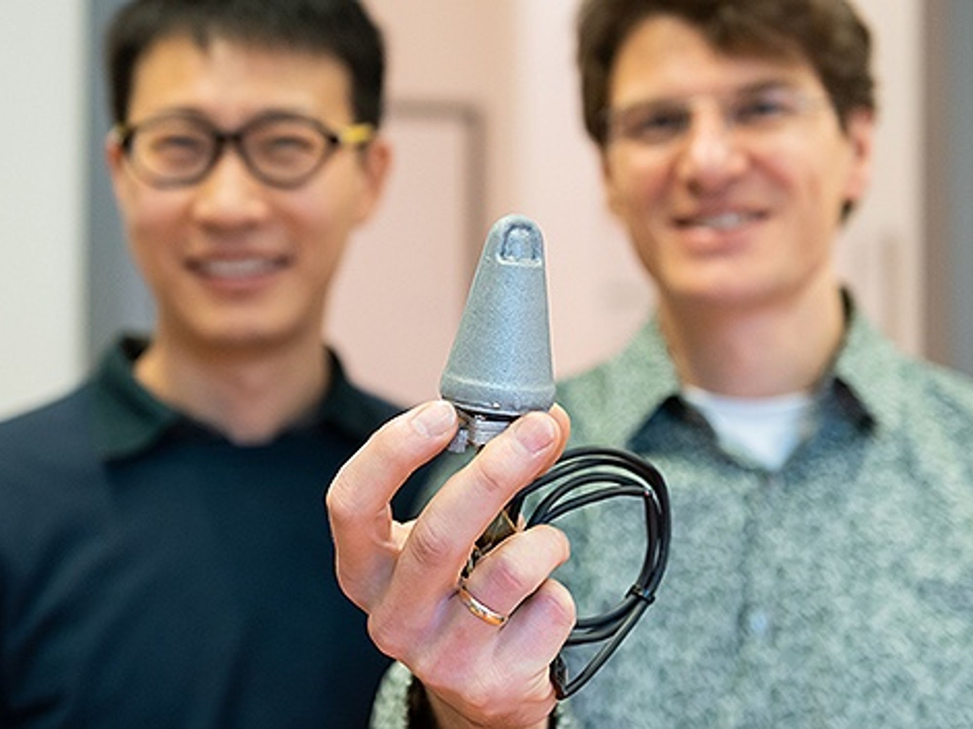 Georg Martius (right), research group leader at the Max Planck Institute, and his doctoral student Huanbo Sun hold a robotic thumb that they developed together at the Institute Georg Martius (right), research group leader at the Max Planck Institute, and his doctoral student Huanbo Sun hold a robotic thumb that they developed together at the Institute