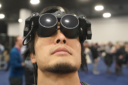 Takuma Iwasa demonstrates the Megane X at the Shiftall stand during the CES technology fair. The Megane X is an ultra-light and ultra-compact VR headset that is compatible with SteamVR. Takuma Iwasa demonstrates the Megane X at the Shiftall stand during the CES technology fair. The Megane X is an ultra-light and ultra-compact VR headset that is compatible with SteamVR.