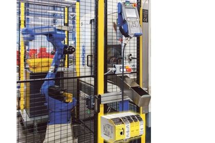 A_Industrial robot behind the safety fence A_Industrial robot behind the safety fence