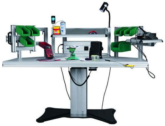 Electrically height-adjustable soldering table