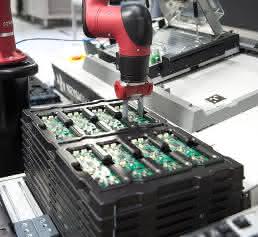 Sawyer places the circuit boards in a test adapter