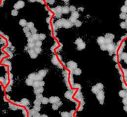 Kolloidales Gel aufgenommen mit einem Konfokalmikroskop. Die Bildung eines solchen Gels geht einher mit gerichteten Ketten aus Teilchen (hier rot illustriert), die das gesamte System durchspannen. (Bild: Ronja Capellmann / Michael Schmiedeberg)