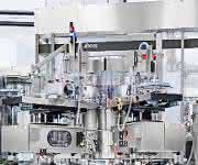 PET bottle line; Triblock combines stretch blow molder, labeler and filler with continuous neck handling of PET bottles. (Image: KHS) PET bottle line: Triblock combines stretch blow molder, labeler and filler with continuous neck handling of PET bottles. (Image: KHS)