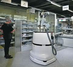 The mobile robot system navigates independently to its workstation