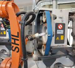 The robot guides the workpieces to the double free belt and contact roller grinding machine for processing