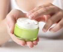 Hands hold cream jar