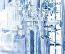 Man working at a small bioreactor in a laboratory.