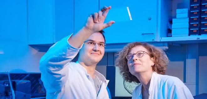 Tobias Claff und Prof. Dr. Christa Müller von der Universität Bonn betrachten einen Glasträger, auf dem sich die Opioid-Rezeptor-Kristalle bilden.