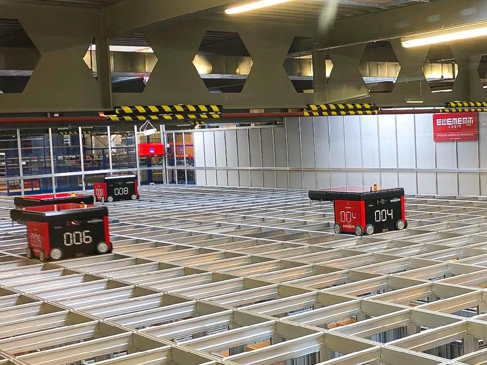 Ten high-speed robots move above the grid.