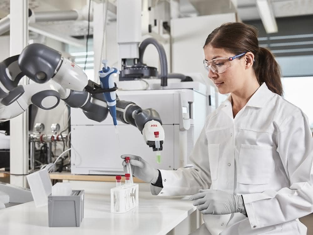 Robot arm and person in lab coat