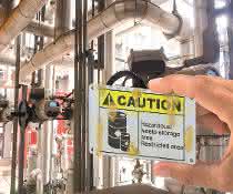 Stainless steel sign with Caution lettering