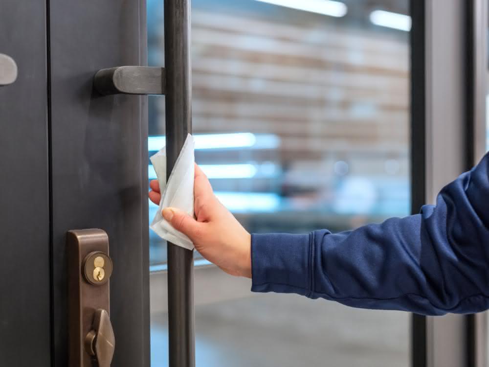 Hygiene protocols in many areas Cleaning a door handle
